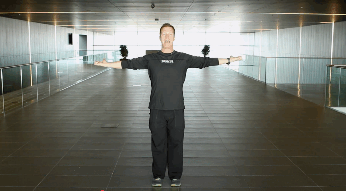 Brian Bradley demonstrating Standing Elbow Curls posture exercise from the Egoscue Method to help realign shoulders and improve posture