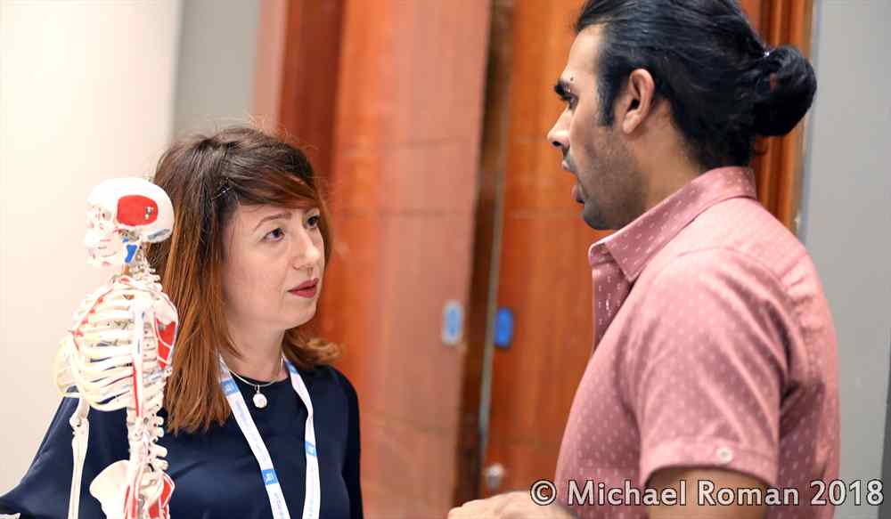 A woman asking a Posture Specialist a question
