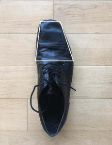 Traditional shoe with narrow toe box tapering inward, restricting natural foot shape