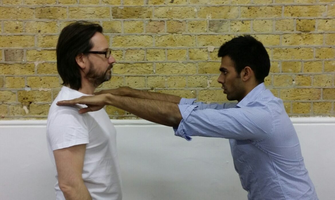Posture specialist assessing client’s alignment in a full-body posture test — expert care focused on root cause, not symptoms