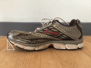 Toe spring shown on a standard trainer lifting toes off the ground
